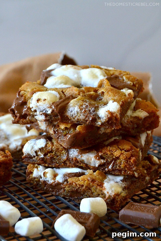 stack of s'mores cookie bars with marshmallows and hershey bars on wire rack