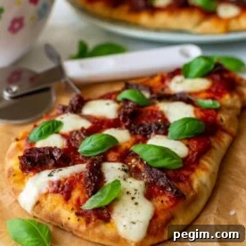 Naan pizza with mozzarella and fresh basil leaves