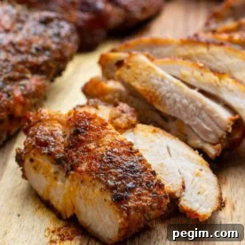 Air fried chicken thigh sliced on a wooden board