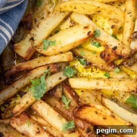Golden roasted Greek potatoes in a baking dish