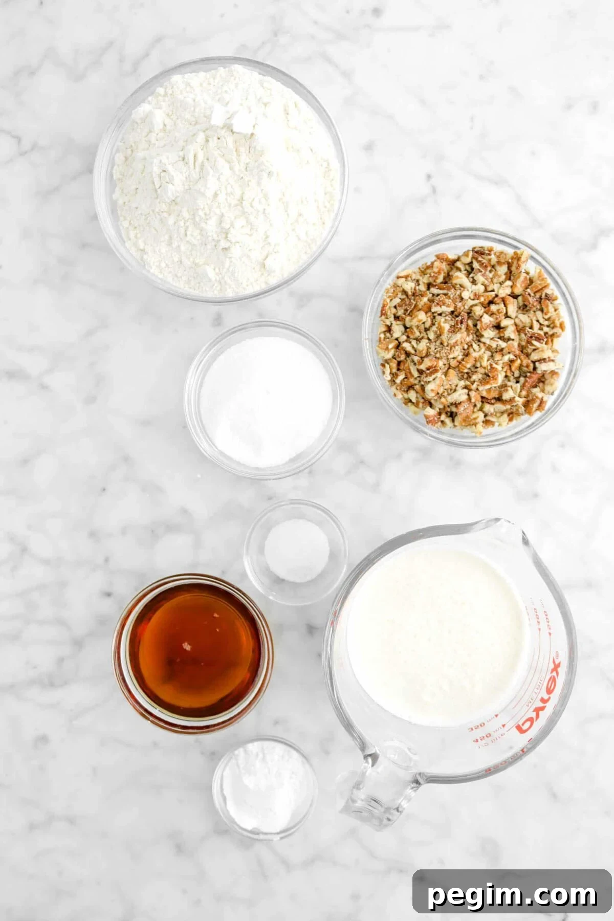 flour, chopped pecans, sugar, salt, maple syrup, milk, and baking powder in glass bowls
