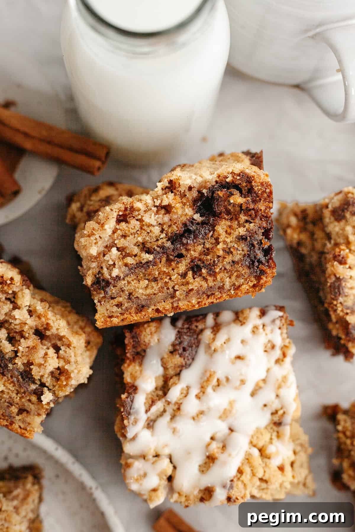 Square slices of banana coffee cake, some slices are drizzled with a white glaze.