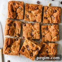 sliced whole wheat chocolate chip cookie bars with glass of milk