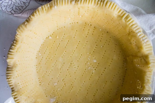 docked pie crust, pricked all over with a fork.
