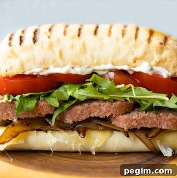 close up horizontal shot of corned beef sandwich on wooden board