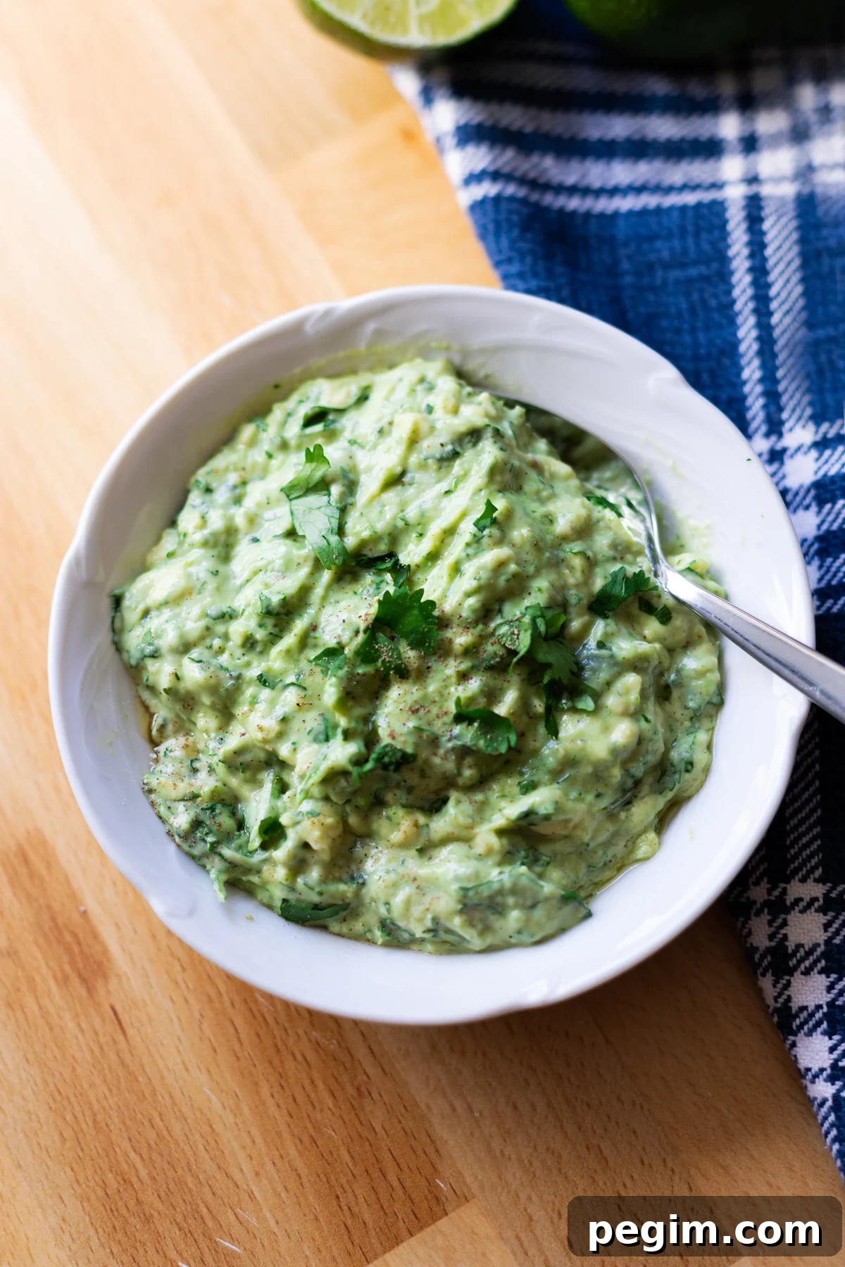 White bowl containing creamy avocado sauce. 