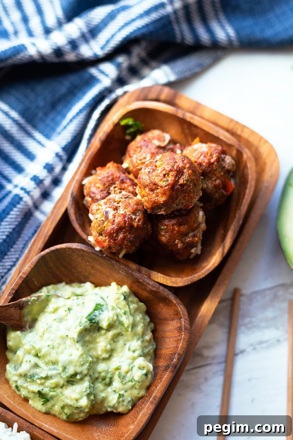 Servicing dish with turkey meatballs and avocado sauce. 