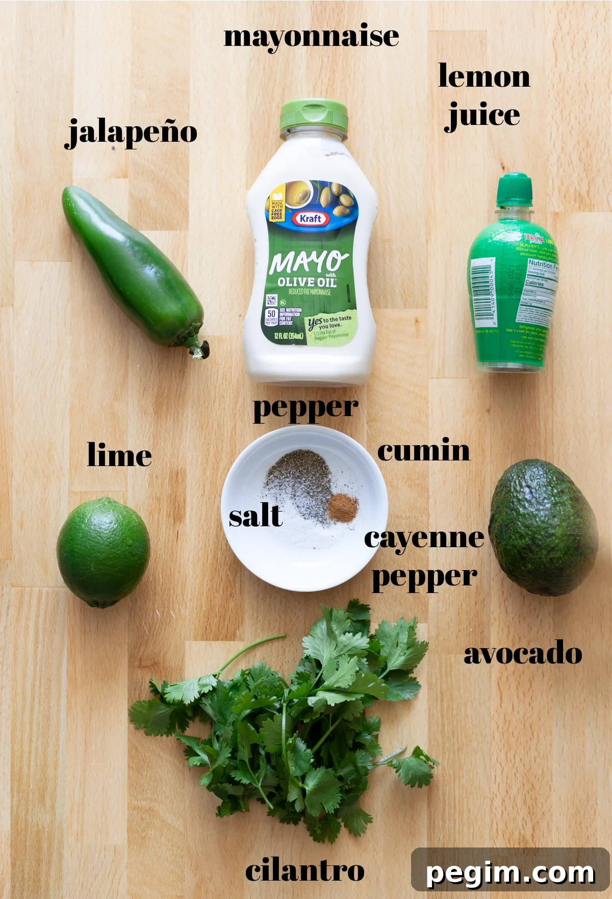 mayonnaise, avocado, lemon and lime juice and seasonings on table. 