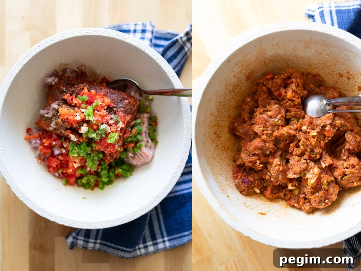 Bowl of turkey and chorizo meat mixture with spices and chopped vegetables. 