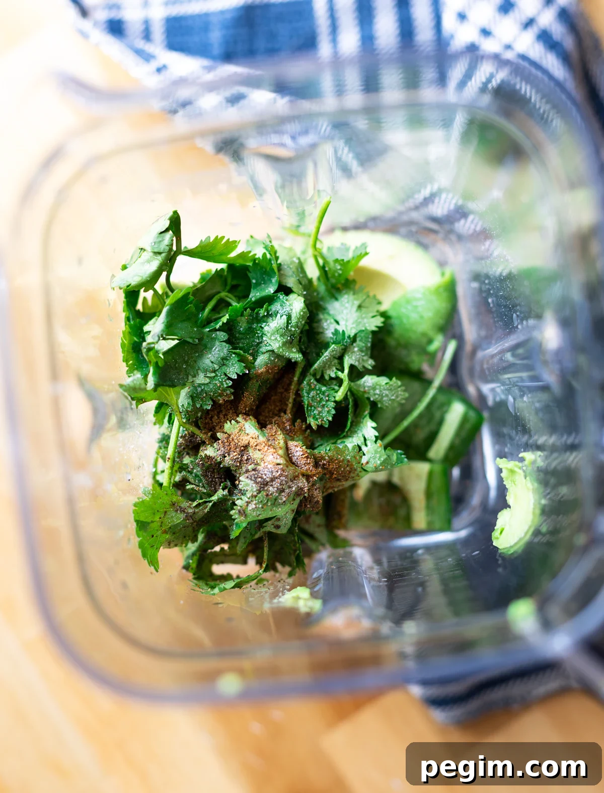 food processor with cilantro, avocado, and seasonings. 