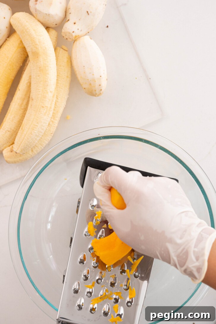 Squash being grated into a bowl.