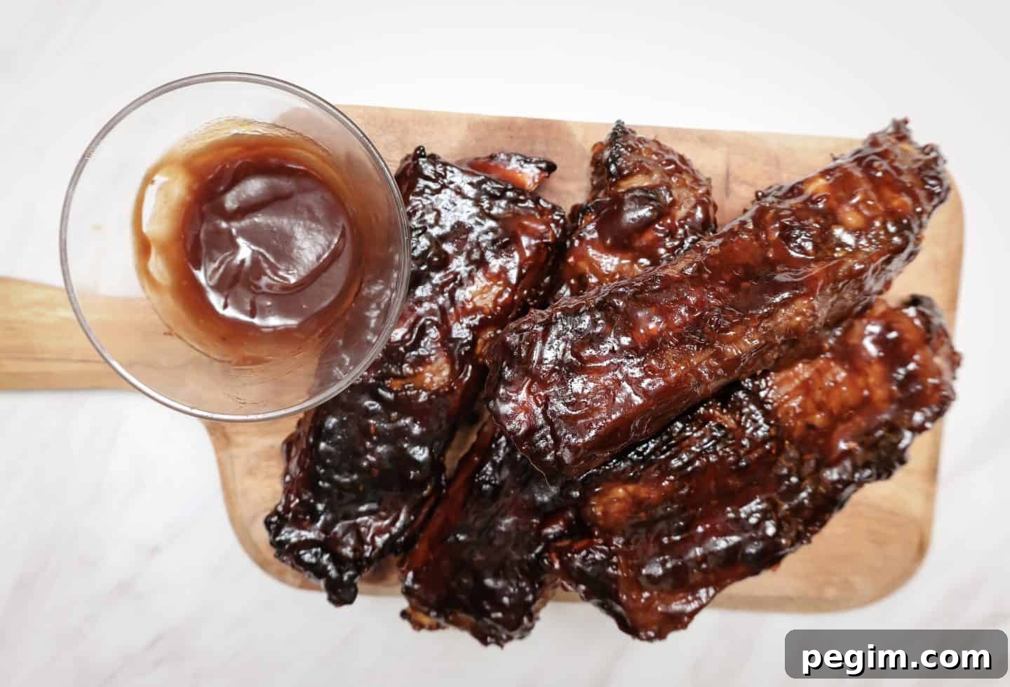 Do you put BBQ sauce on ribs before baking?