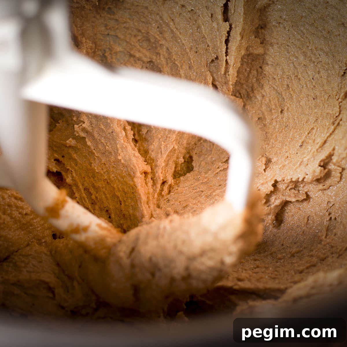 Beating brown sugar and brown butter with an electric mixer until the mixture is light and fluffy.