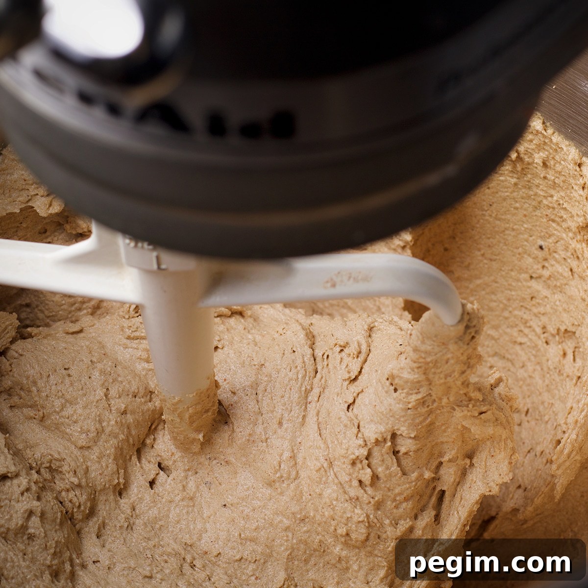 Adding the flour and buttermilk to brown butter cake batter.