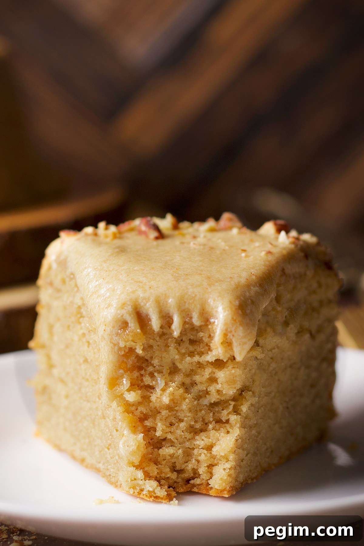 A slice of brown butter cake with a bite taken out of it.