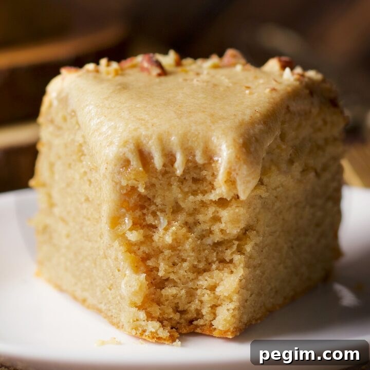 A slice of brown butter cake with a bite taken out of it.