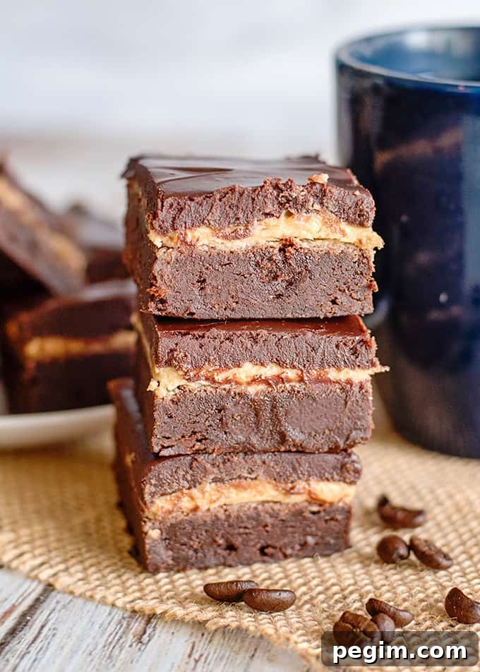 a stack of brownies on a piece of burlap with a mug behind it