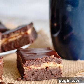 a brownie square on a piece of burlap with a blue mug behind it
