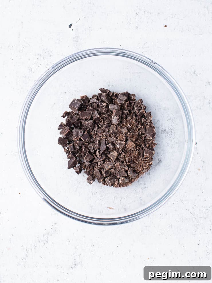Finely chopped up chocolate in a clear bowl.