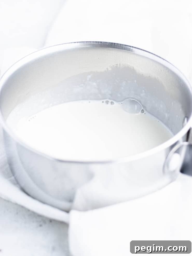 Hot cream in a small silver pot.