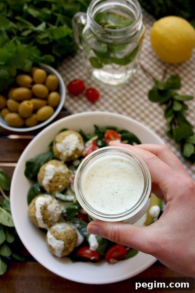 Crispy Baked Falafel with Hazelnuts and Creamy Lemon-Mint Sauce - Holding a Sauce for the Dish