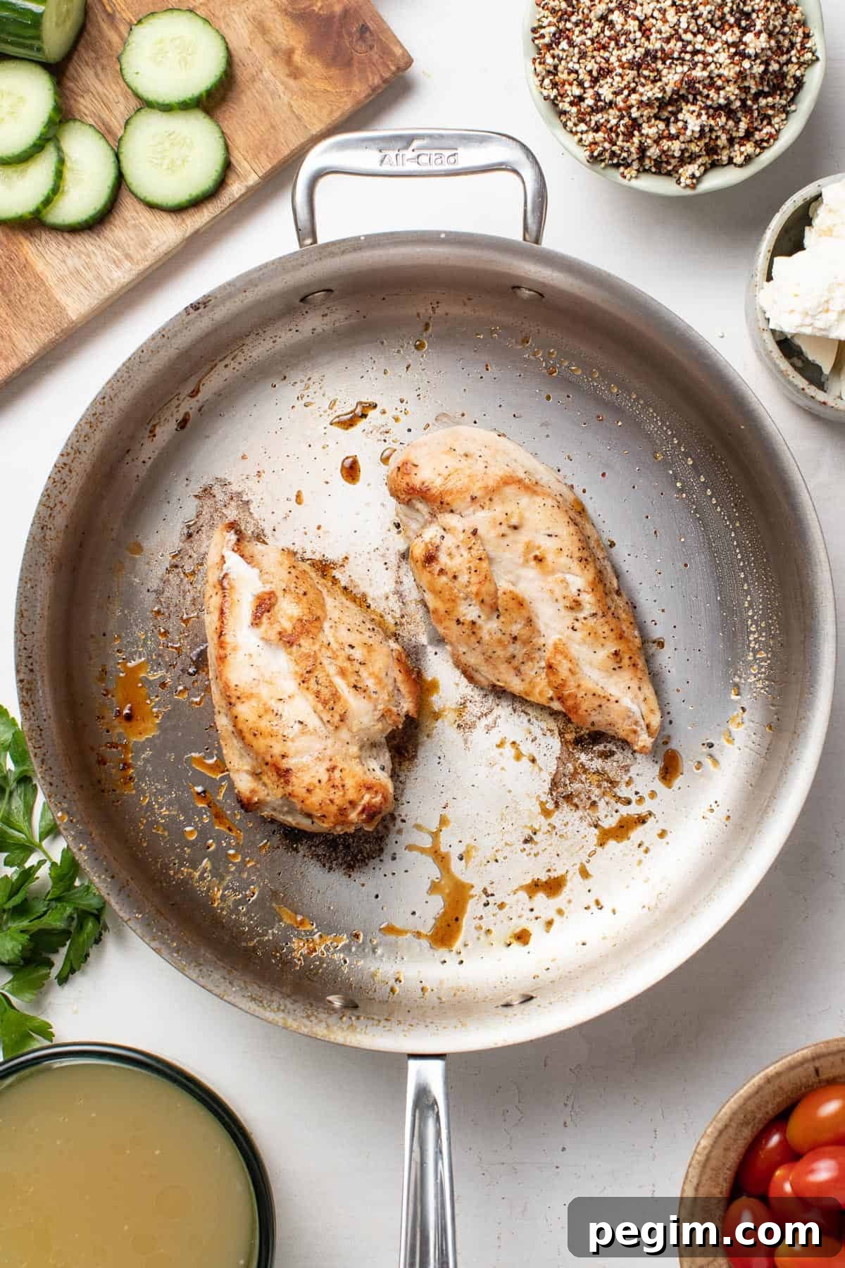 Searing chicken breasts in a pan.