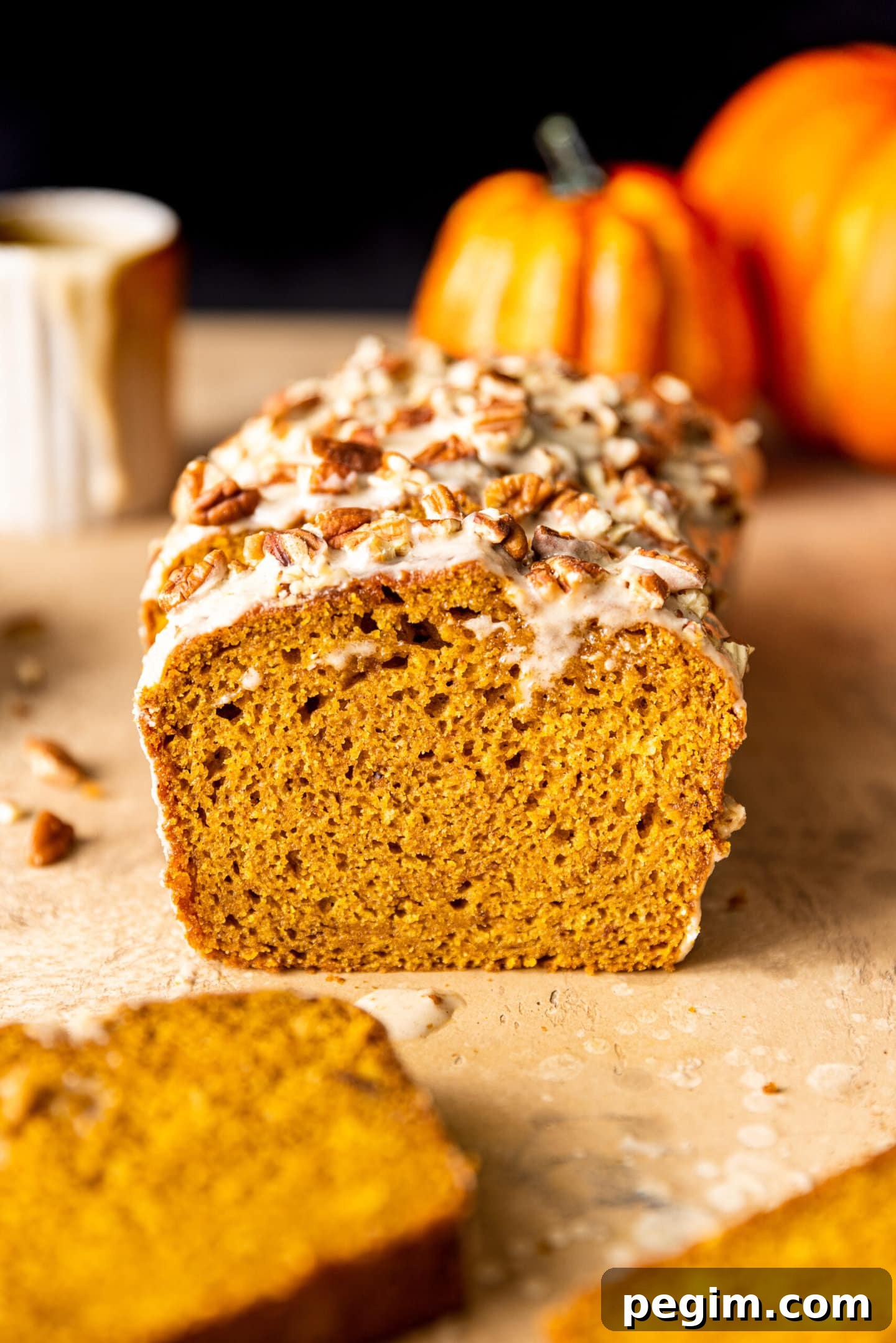 Slices of Maple Glazed Pumpkin Bread with chopped pecans on top