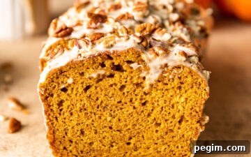 Slices of Maple Glazed Pumpkin Bread with chopped pecans on top