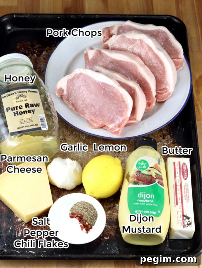 Ingredients for Grilled Pork Chops with lemon garlic sauce: honey, butter, lemon, garlic, dijon mustard, Parmesan cheese, salt, pepper, chili flakes