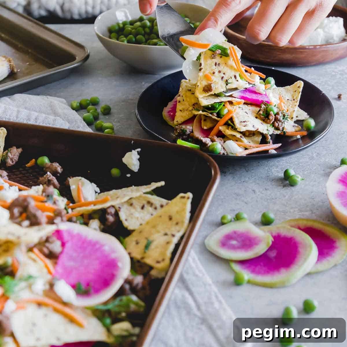 Celebrate spring with these lamb nachos and early spring vegetables on crispy corn tortillas with feta cheese.