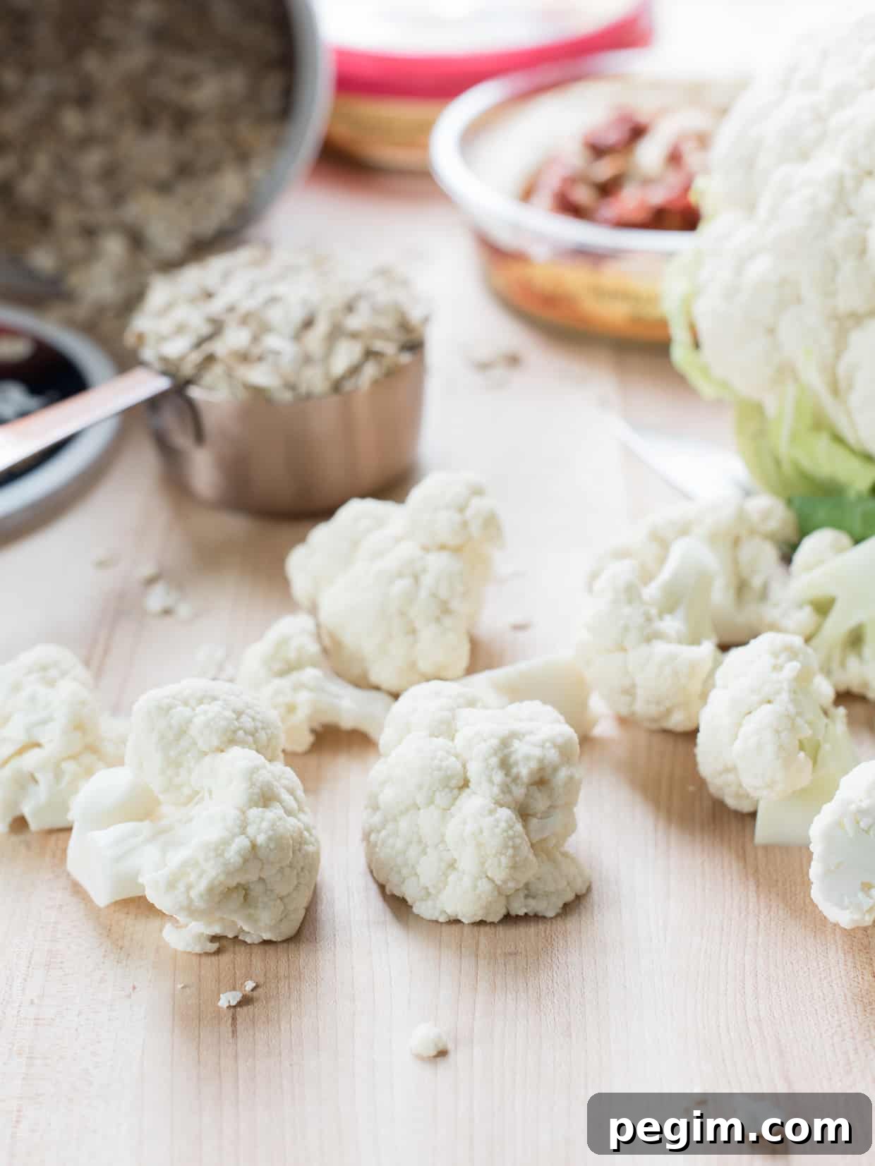 Cauliflower florets on a wooden surface.