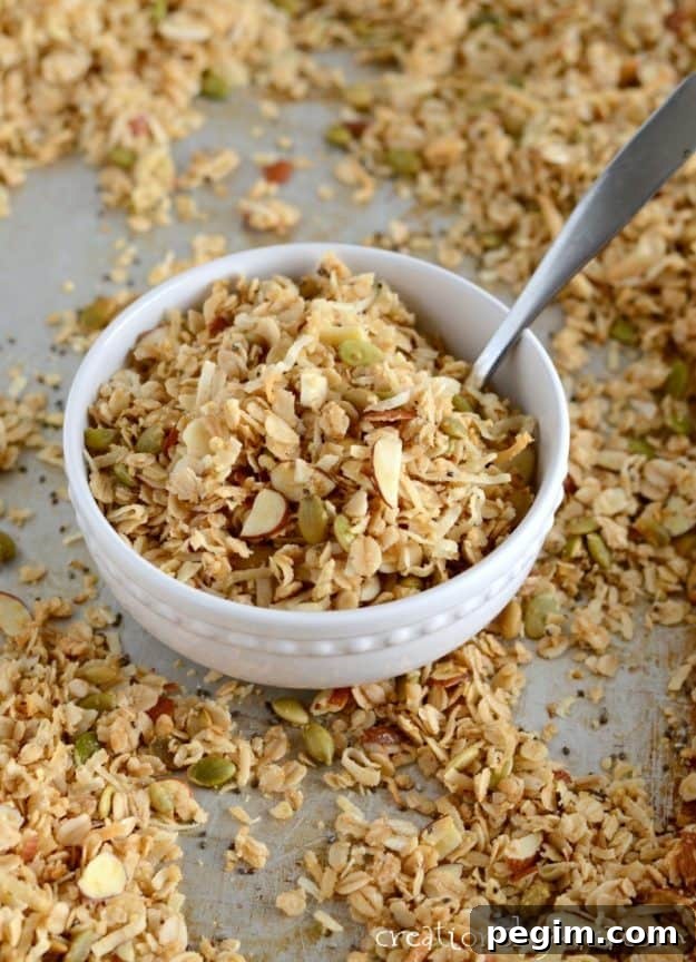 bowl of granola on a cooking sheet with granola
