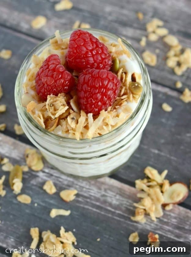 overhead shot of coconut granola with yogurt and raspberries