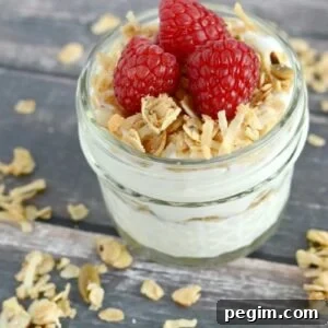 Homemade granola with yogurt and fresh raspberries. Perfect for breakfast or snacking!