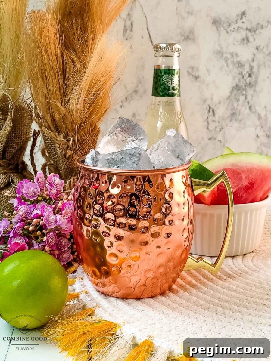 Filling the copper mug with cubed ice.