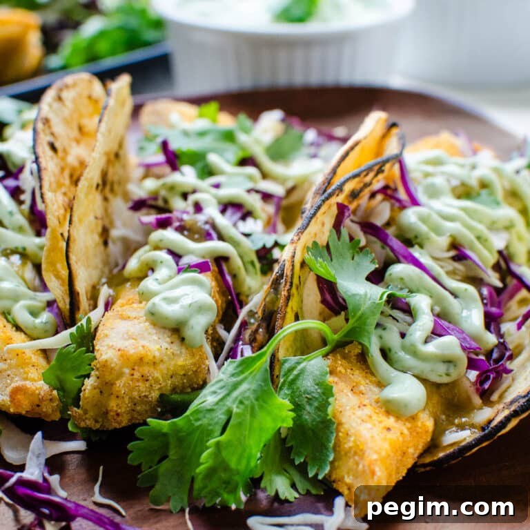 a platter of baked fish tacos with lime crema.