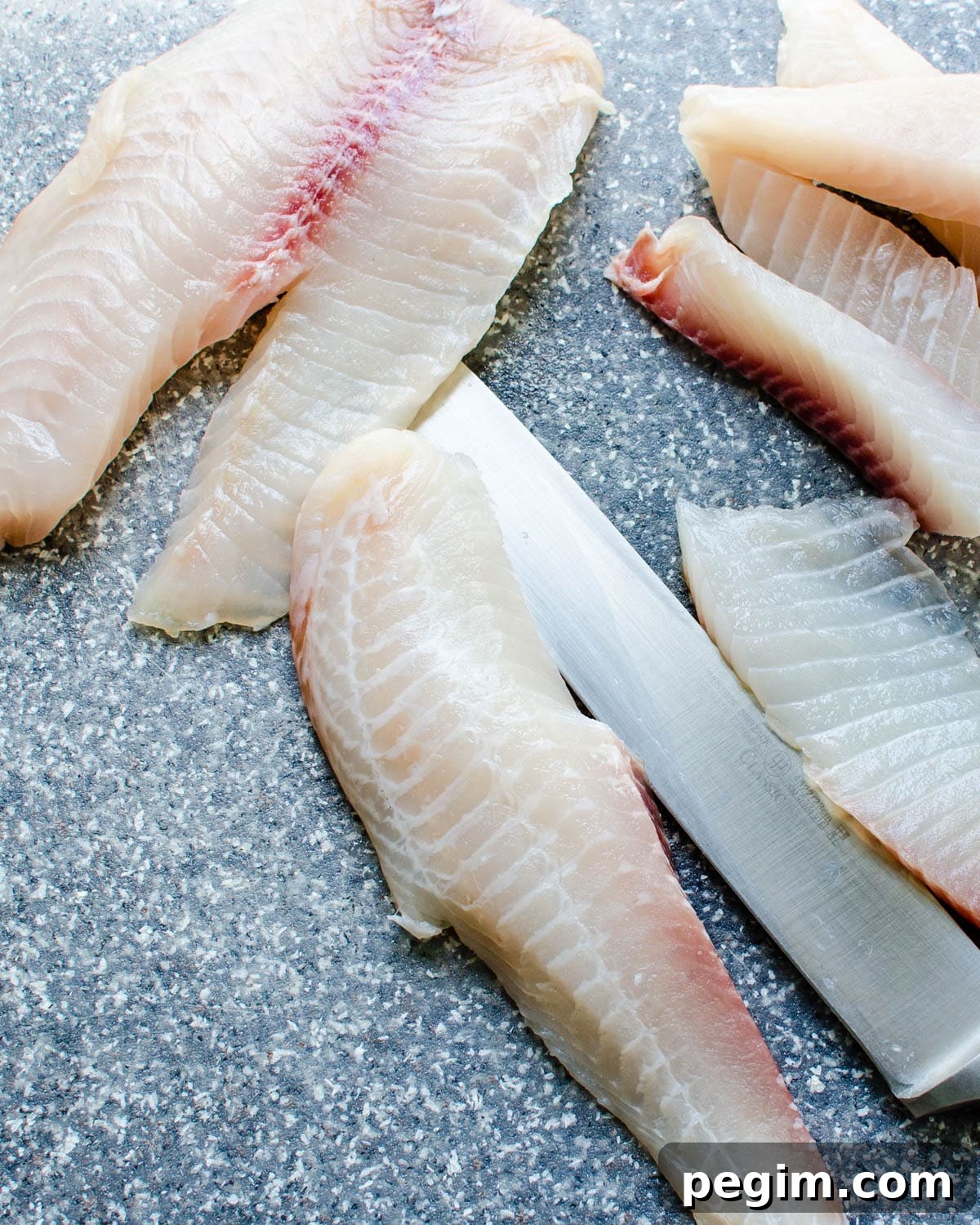 portioning out the tilapia fillets. 