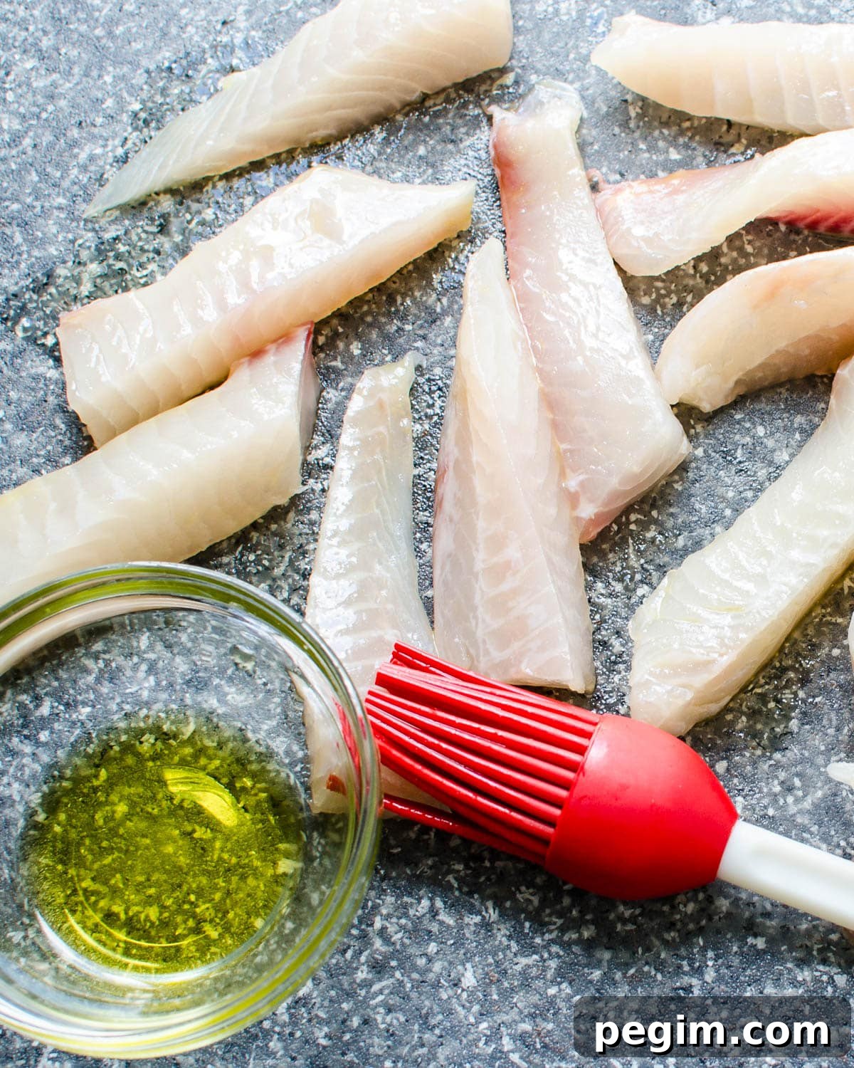 brushing the fish with oil.