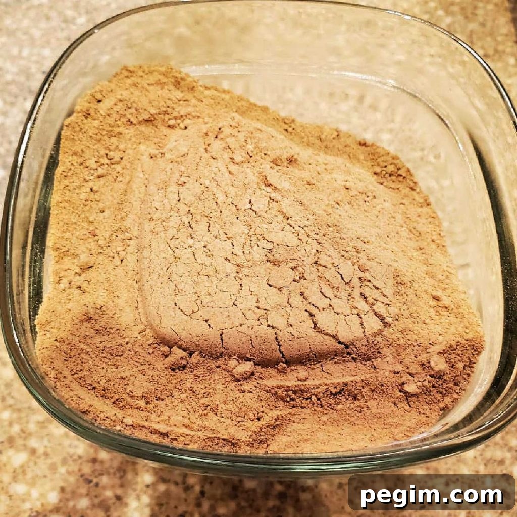 A close up of a glass dish with spent grain flour in it.