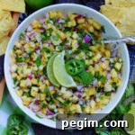 A bowl of fresh pineapple salsa ready to eat with tortilla chips as a dip