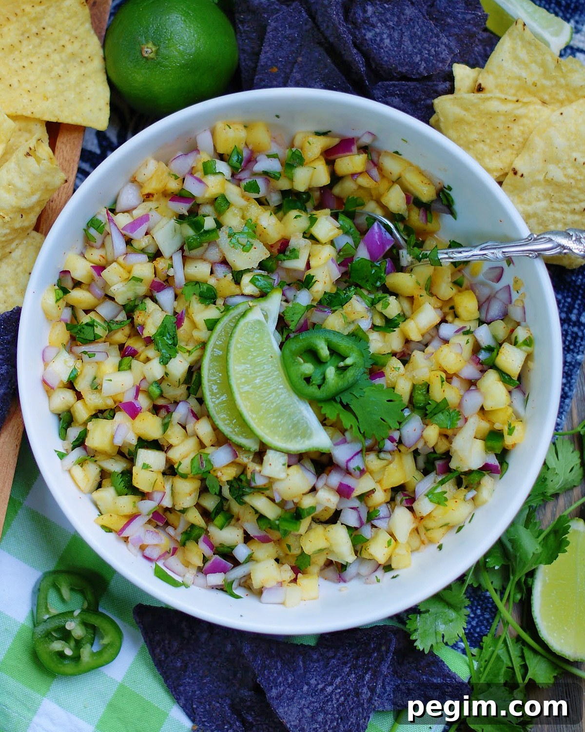 A bowl of fresh pineapple salsa ready to eat with tortilla chips as a dip