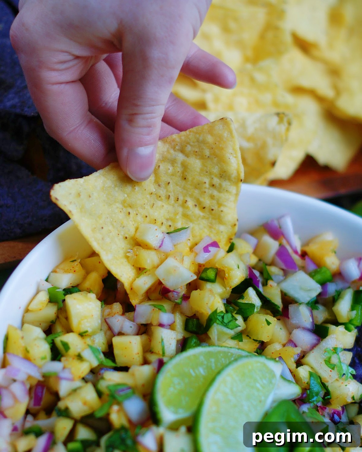 A salsa dip recipe made with pineapples served with tortilla chips