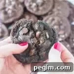 hands breaking a chocolate mint cookie in half