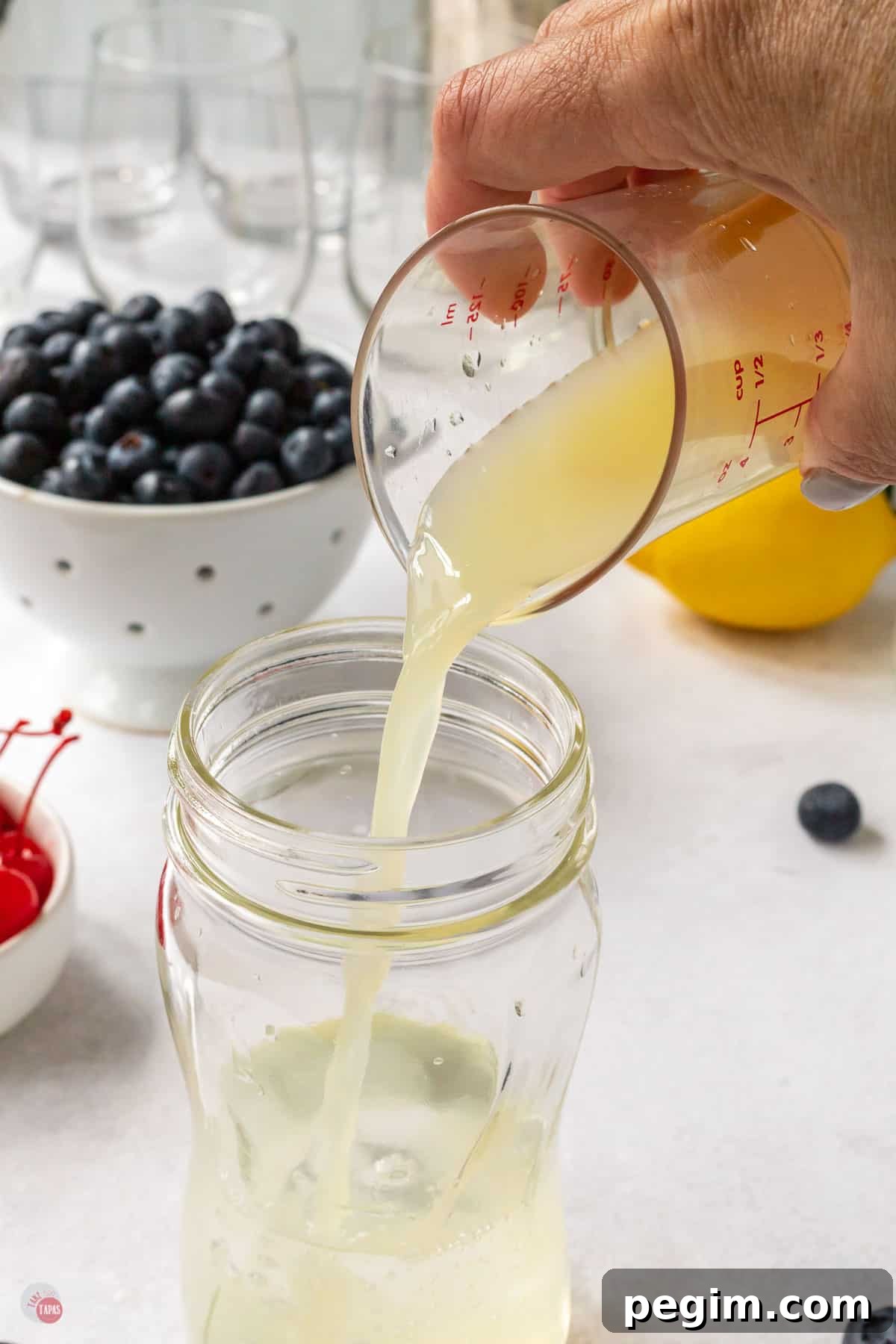 lemon juice pouring into a glass
