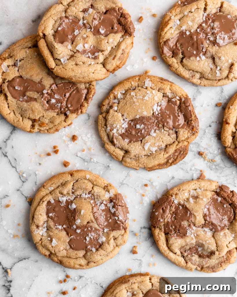Chewy golden Toffee Milk Chocolate Chip Cookies on marble counter