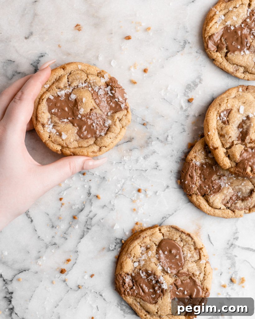 Chewy golden Toffee Milk Chocolate Chip Cookies on marble counter