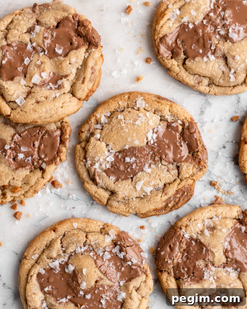 Chewy golden Toffee Milk Chocolate Chip Cookies on marble counter