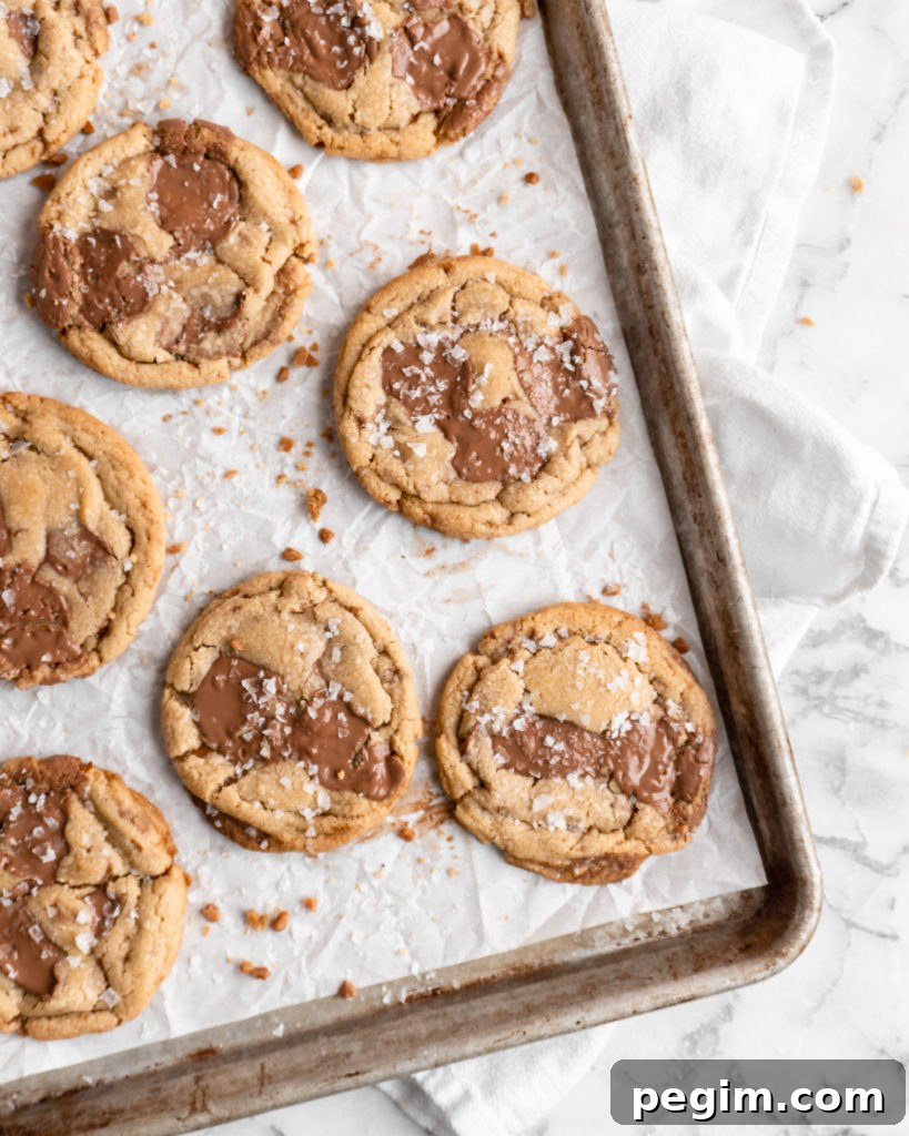 Chewy golden Toffee Milk Chocolate Chip Cookies on baking sheet