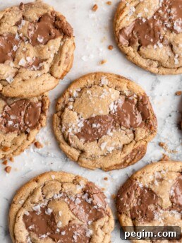 Chewy golden Toffee Milk Chocolate Chip Cookies on marble counter