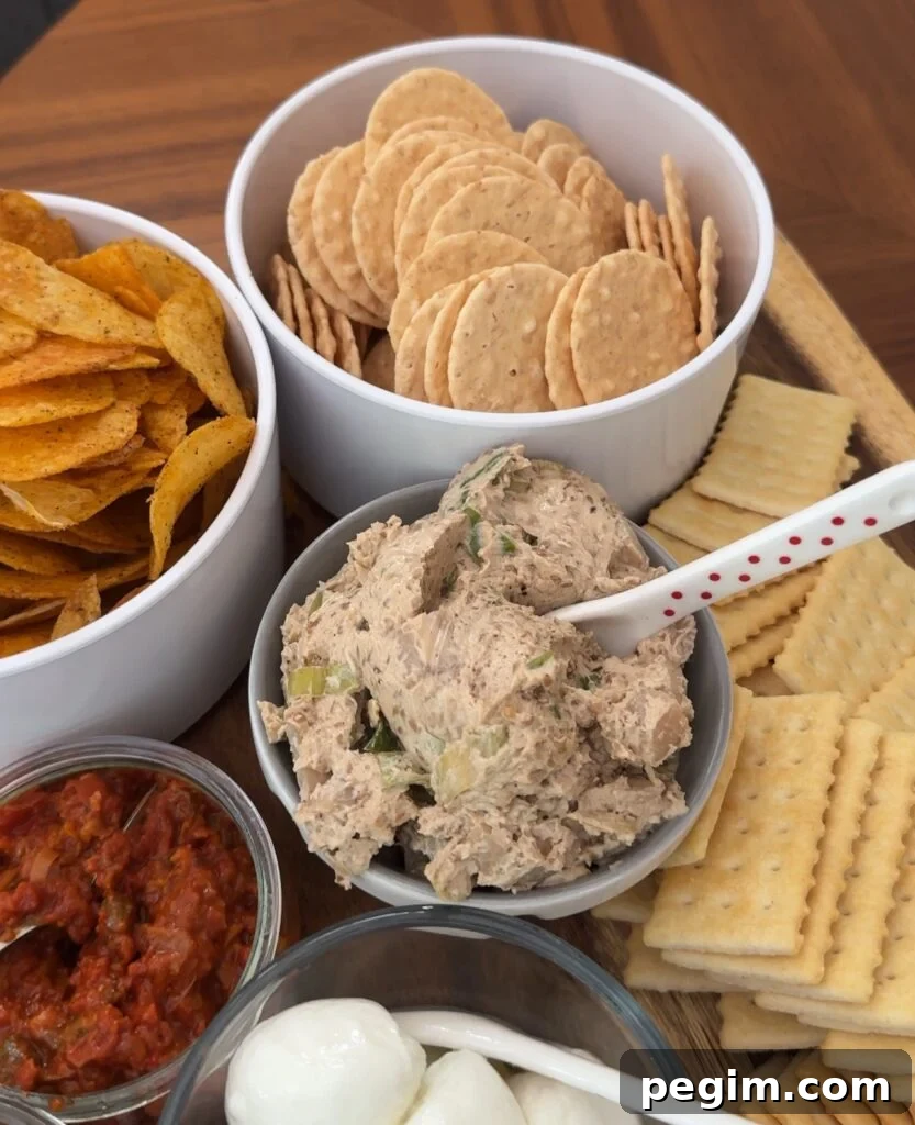 A grazing board with the dip and various crackers and chips